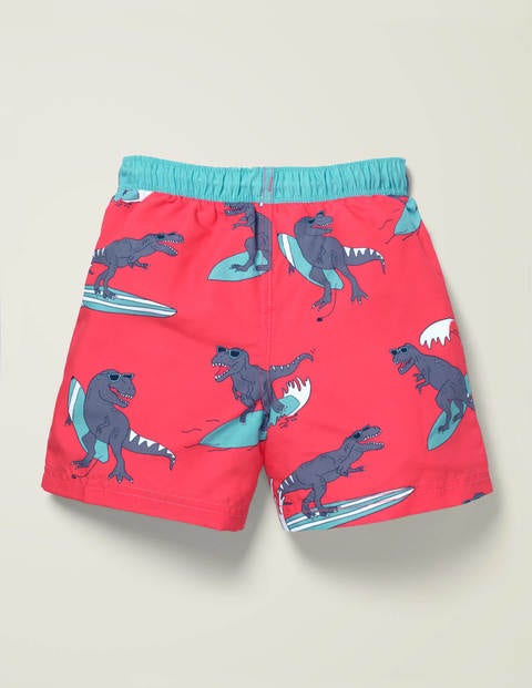 Badeshorts - Korallenrosa, Surfende Dinos Badeshorts - Korallenrosa, Surfende Dinos