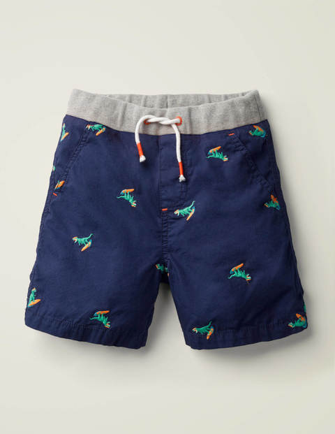 Fröhliche Urlaubsshorts - Dunkelblau, Surfende Dinos Fröhliche Urlaubsshorts - Dunkelblau, Surfende Dinos
