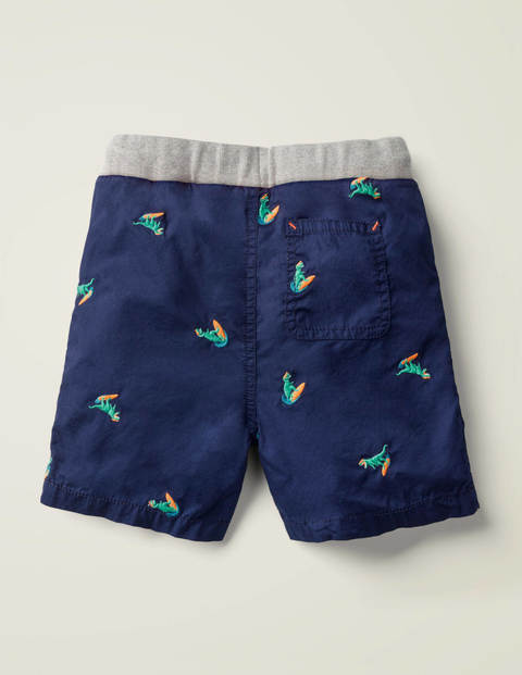 Fröhliche Urlaubsshorts - Dunkelblau, Surfende Dinos Fröhliche Urlaubsshorts - Dunkelblau, Surfende Dinos