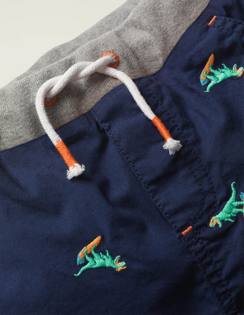 Fröhliche Urlaubsshorts - Dunkelblau, Surfende Dinos Fröhliche Urlaubsshorts - Dunkelblau, Surfende Dinos